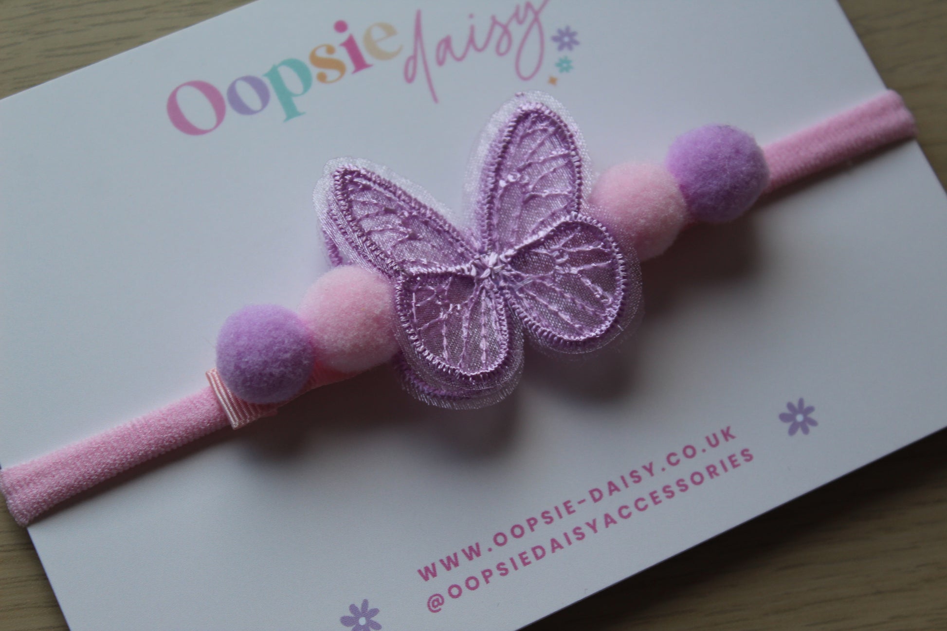 Pink and purple butterfly and pom pom baby headband