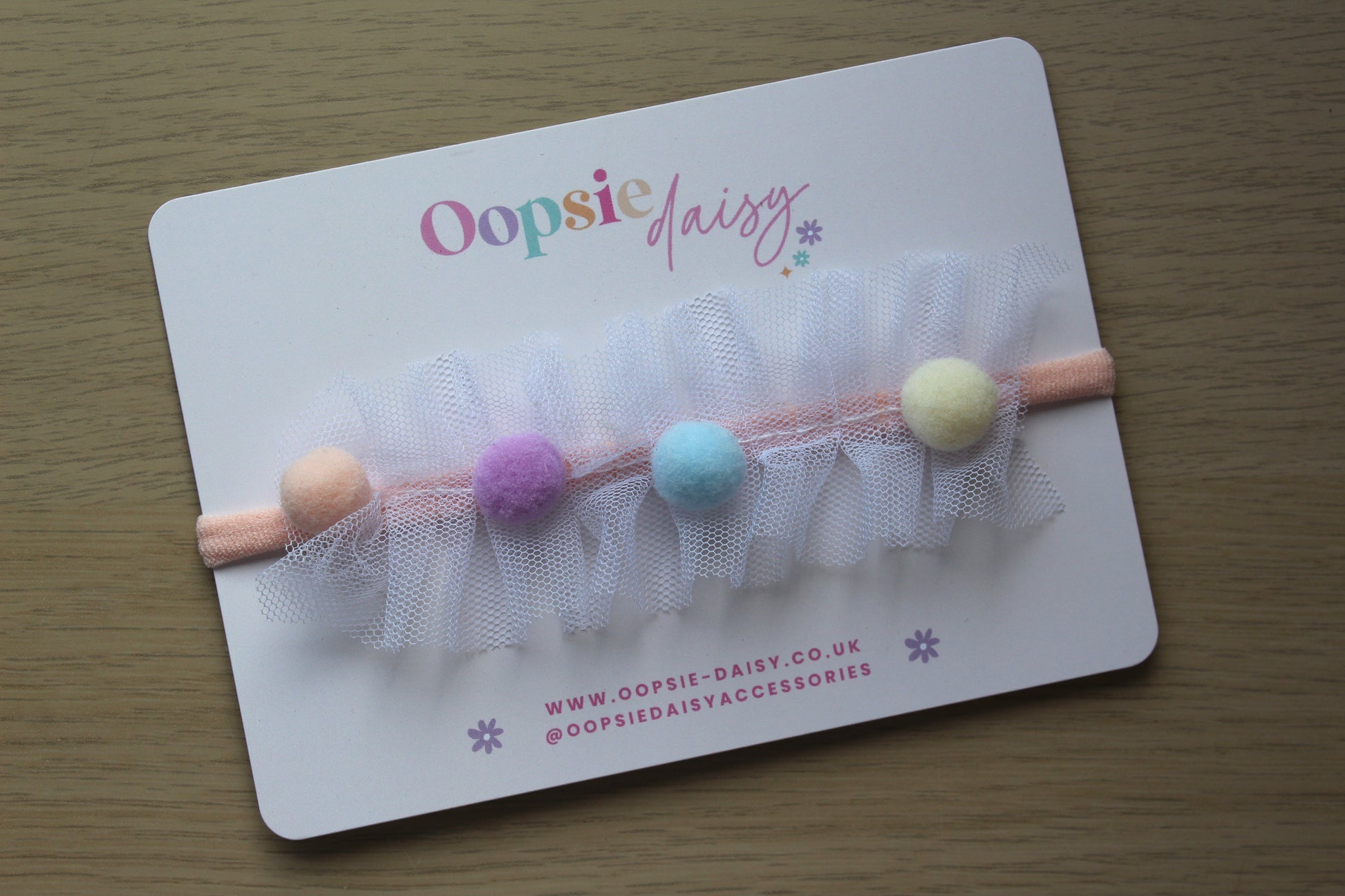 Baby headband with pom poms