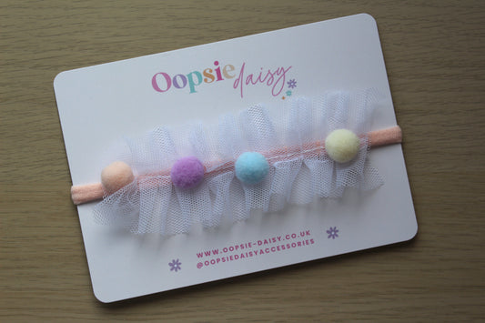 Baby headband with pom poms