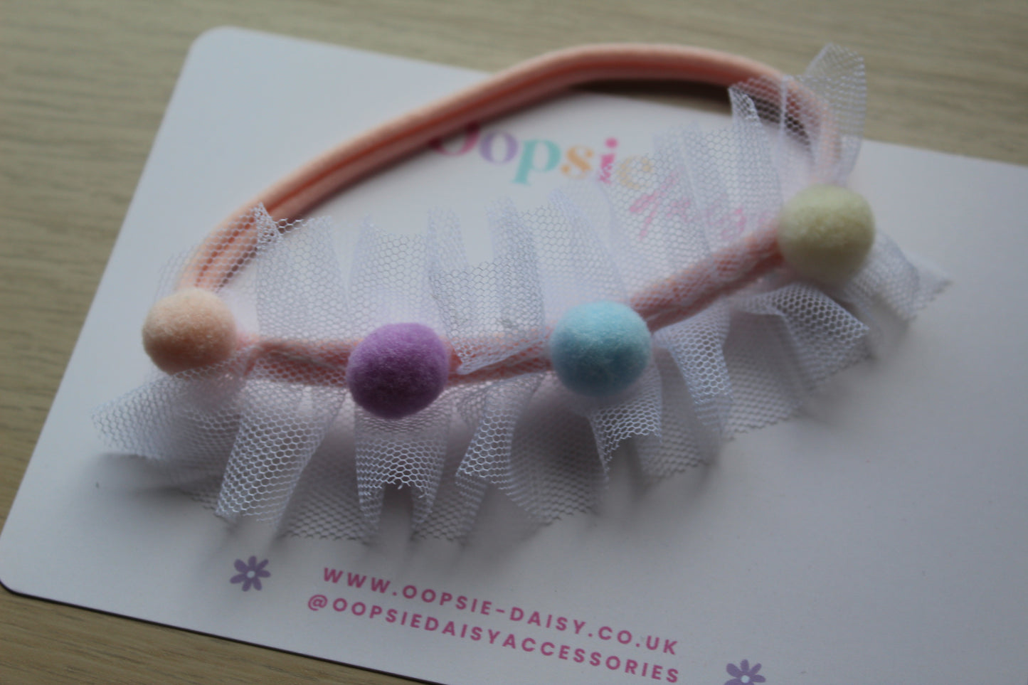Headband with colourful pom poms