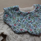 Scallop shaped baby bib with ditsy flowers
