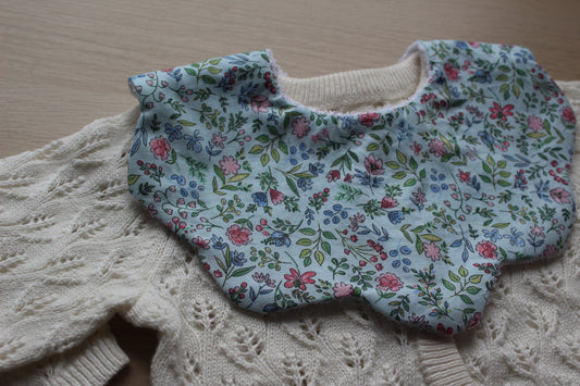 Scallop shaped baby bib with ditsy flowers
