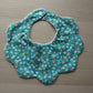Baby bib with scallop shape and ditsy flowers