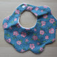 scallop bib with floral design and polka dot