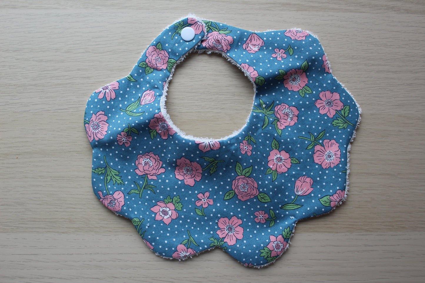 scallop bib with floral design and polka dot