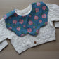 Rose and polka dot themed scallop baby bib