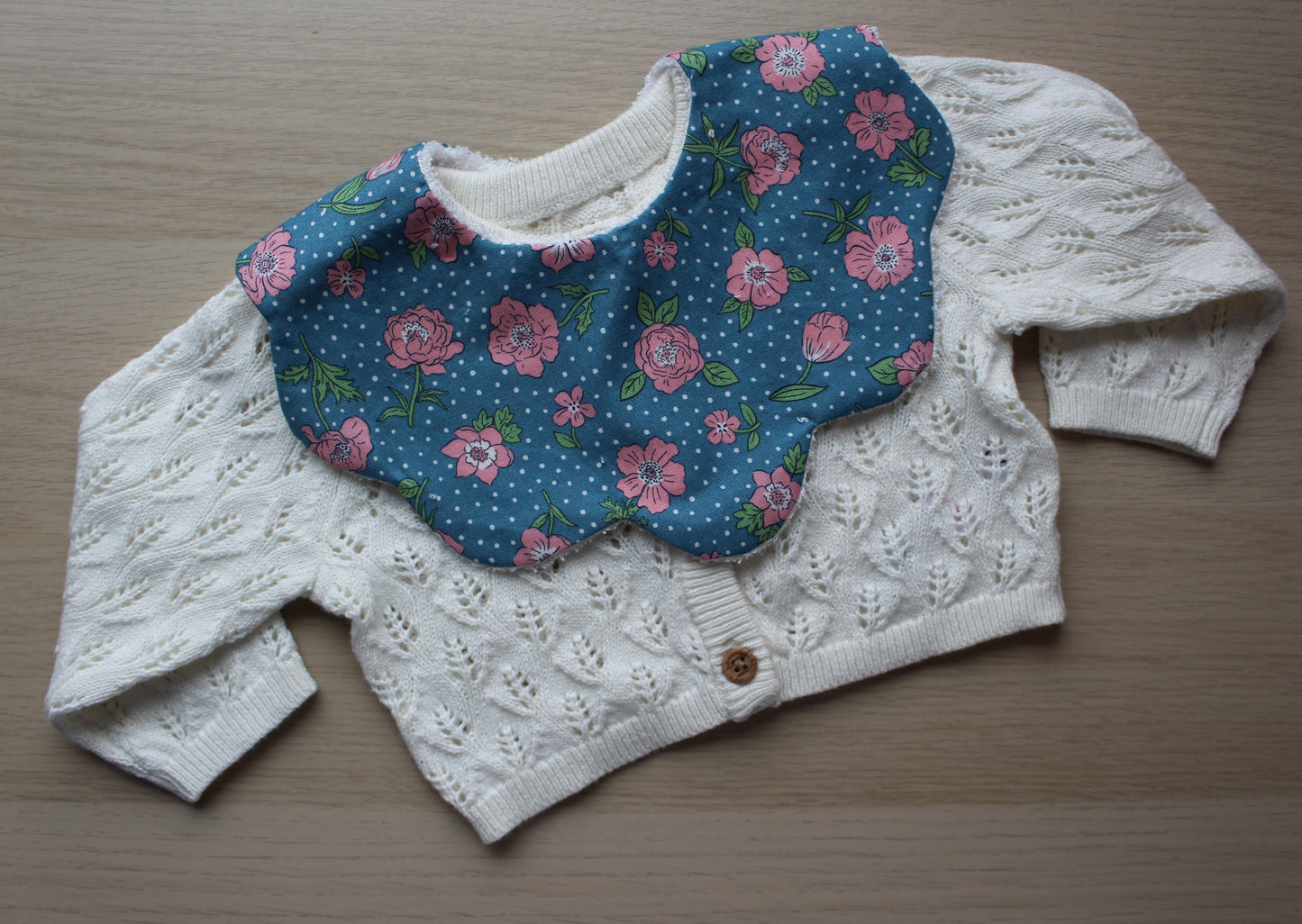 Rose and polka dot themed scallop baby bib