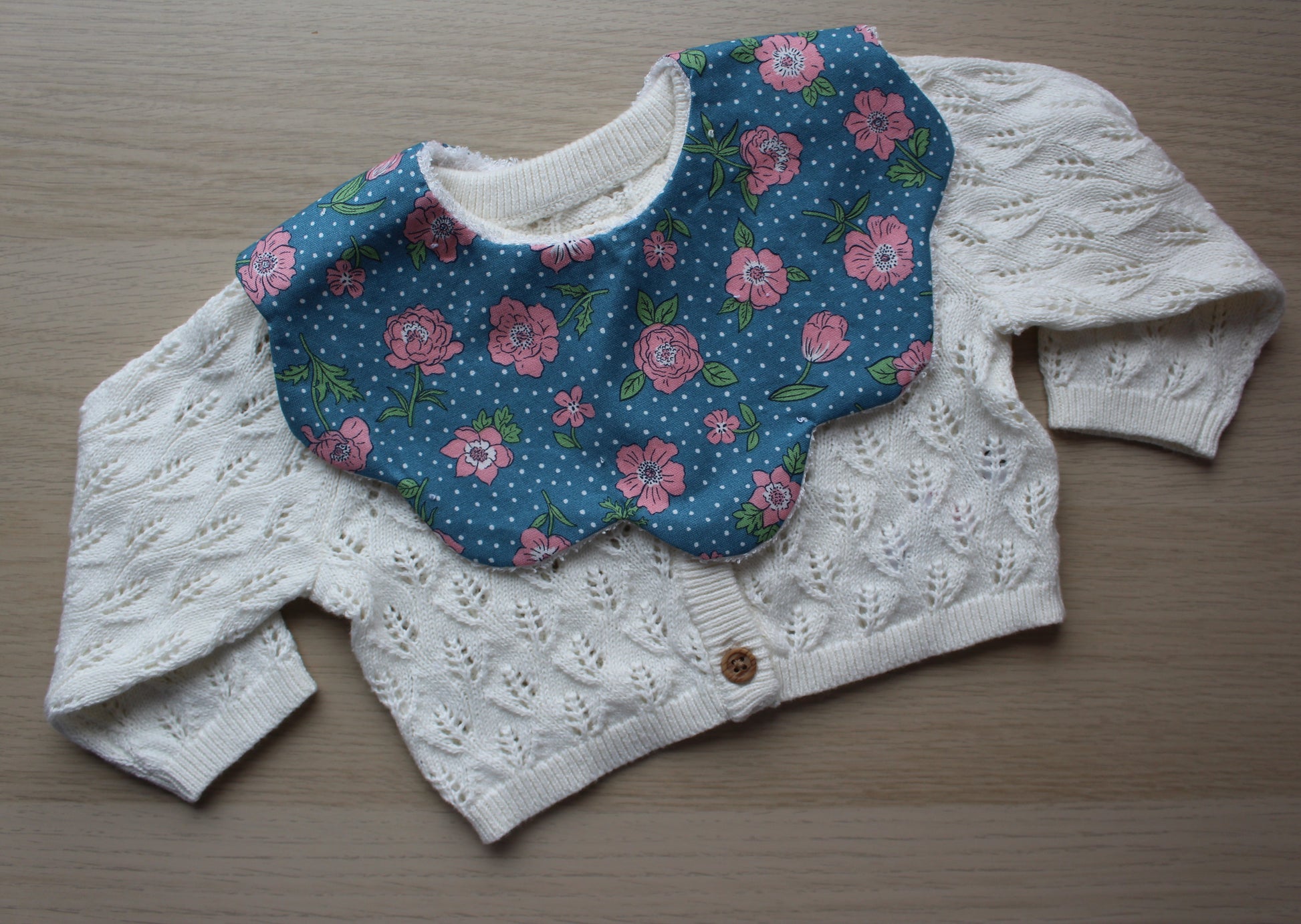 Rose and polka dot themed scallop baby bib