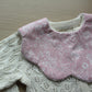 Scallop baby bib with pale pink flowers