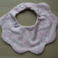 Baby bib with scallop shape and subtle flowers