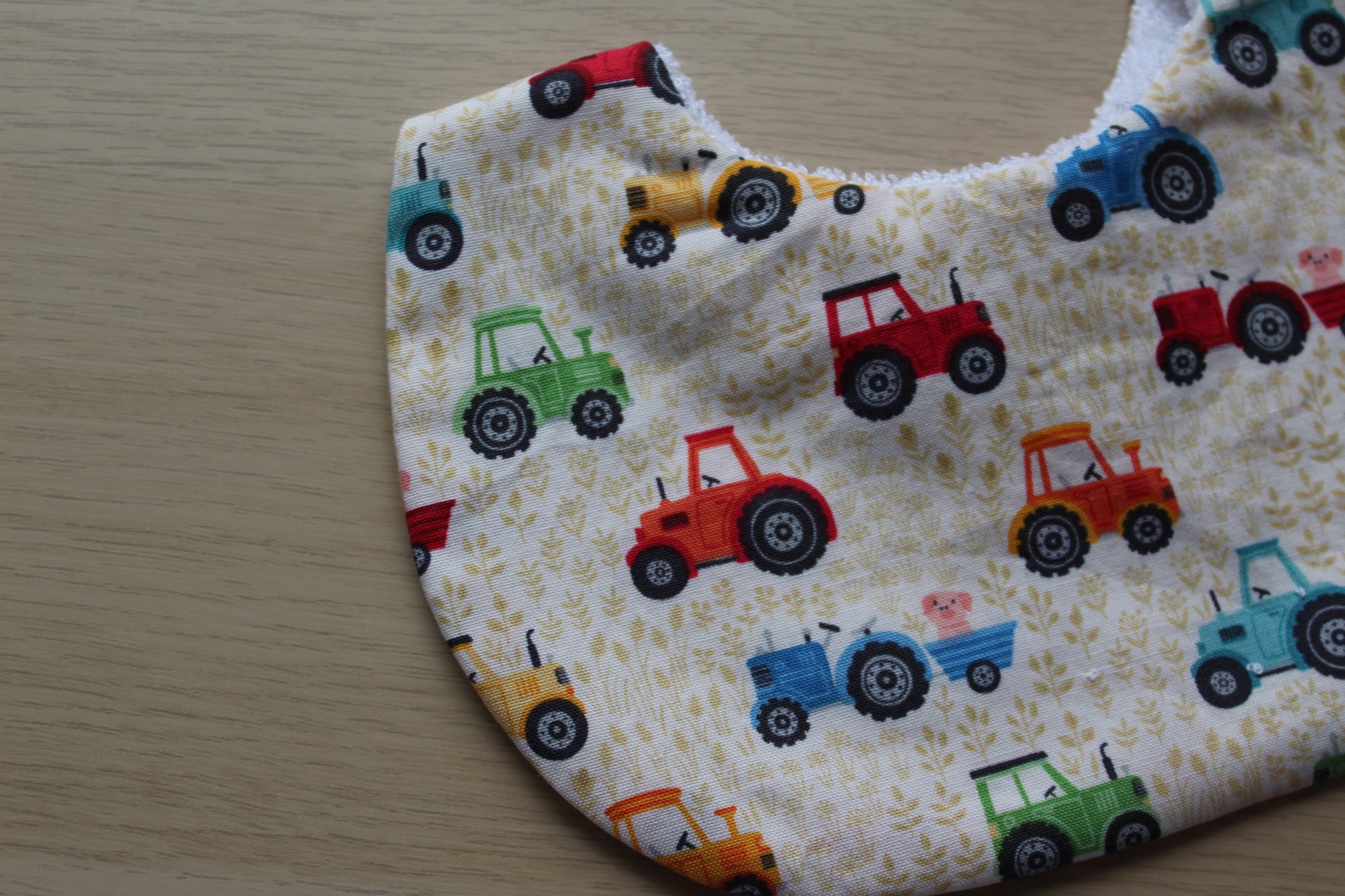 Baby bib with cute tractor farmyard design