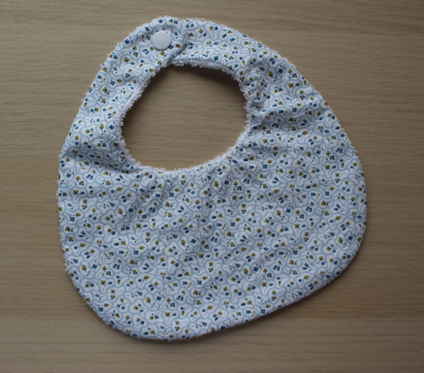 Ditsy blue and white floral baby bib made with Liberty fabric