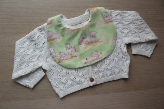 Rounded baby bib with cute little pig design