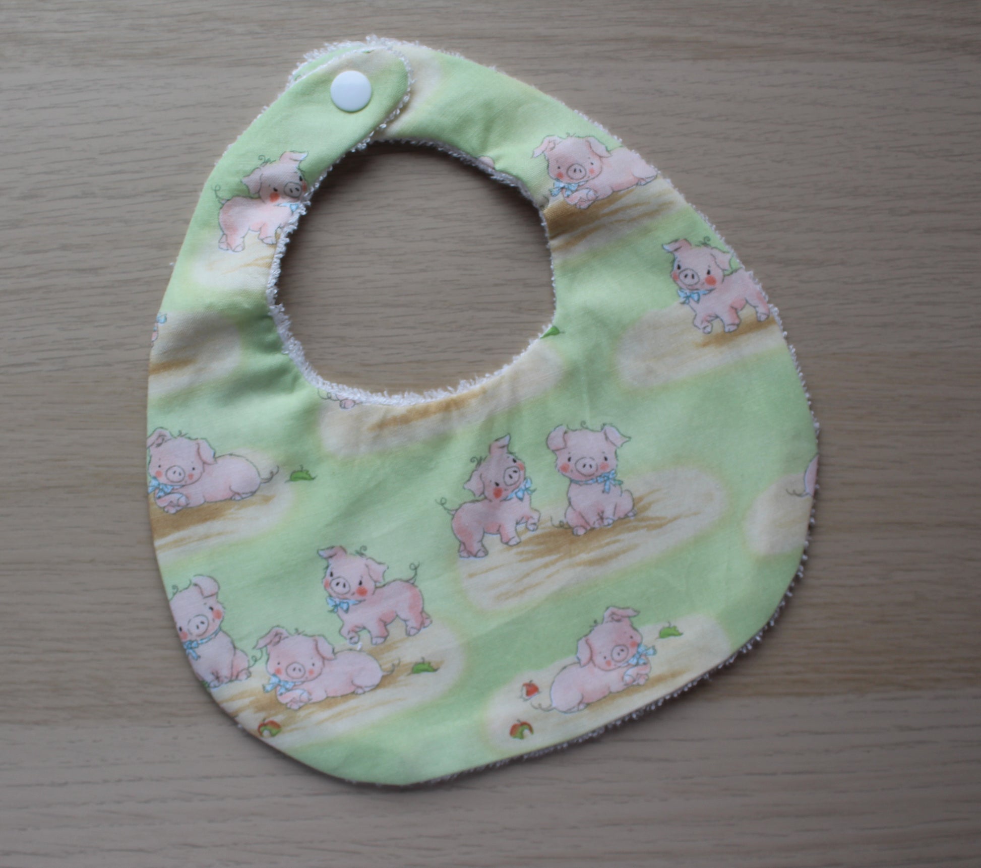 Pig baby bib with green background