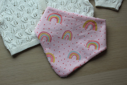Pink dribble baby bib with rainbow polka dot design