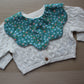 Scallop baby bib with ditsy floral pattern