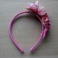 Pink headband with flower embellishments