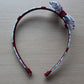 Headband with burgundy floral design and bow