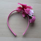 Pink floral headband on a deep pink band