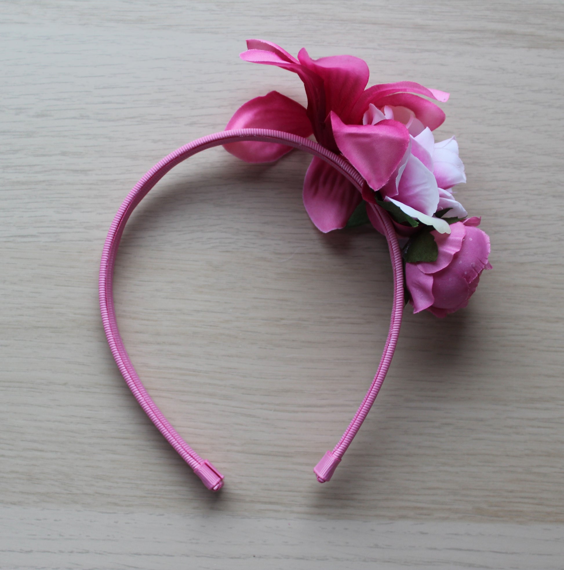 Pink floral headband on a deep pink band