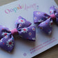 Hair clips with pink and purple daisy flowers