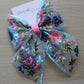 Blue and pink embroidered hair bow