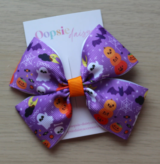 Halloween-themed purple bow with pumpkins, ghosts, and bats 