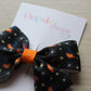 Subtle Halloween hair bow featuring pumpkins, stars and spiders