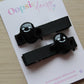Hair clips with black ghost design