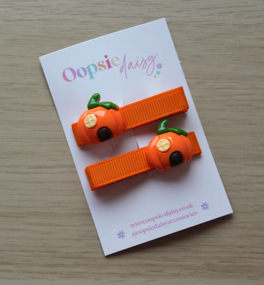 Orange hair clips with pumpkin house design