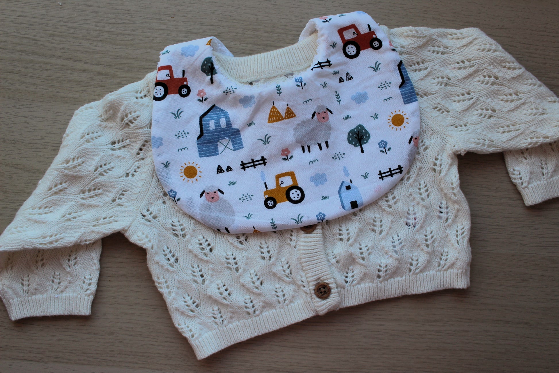 Baby bib with farm themed design