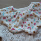 Scallop baby bib with pretty ditsy butterfly and floral design