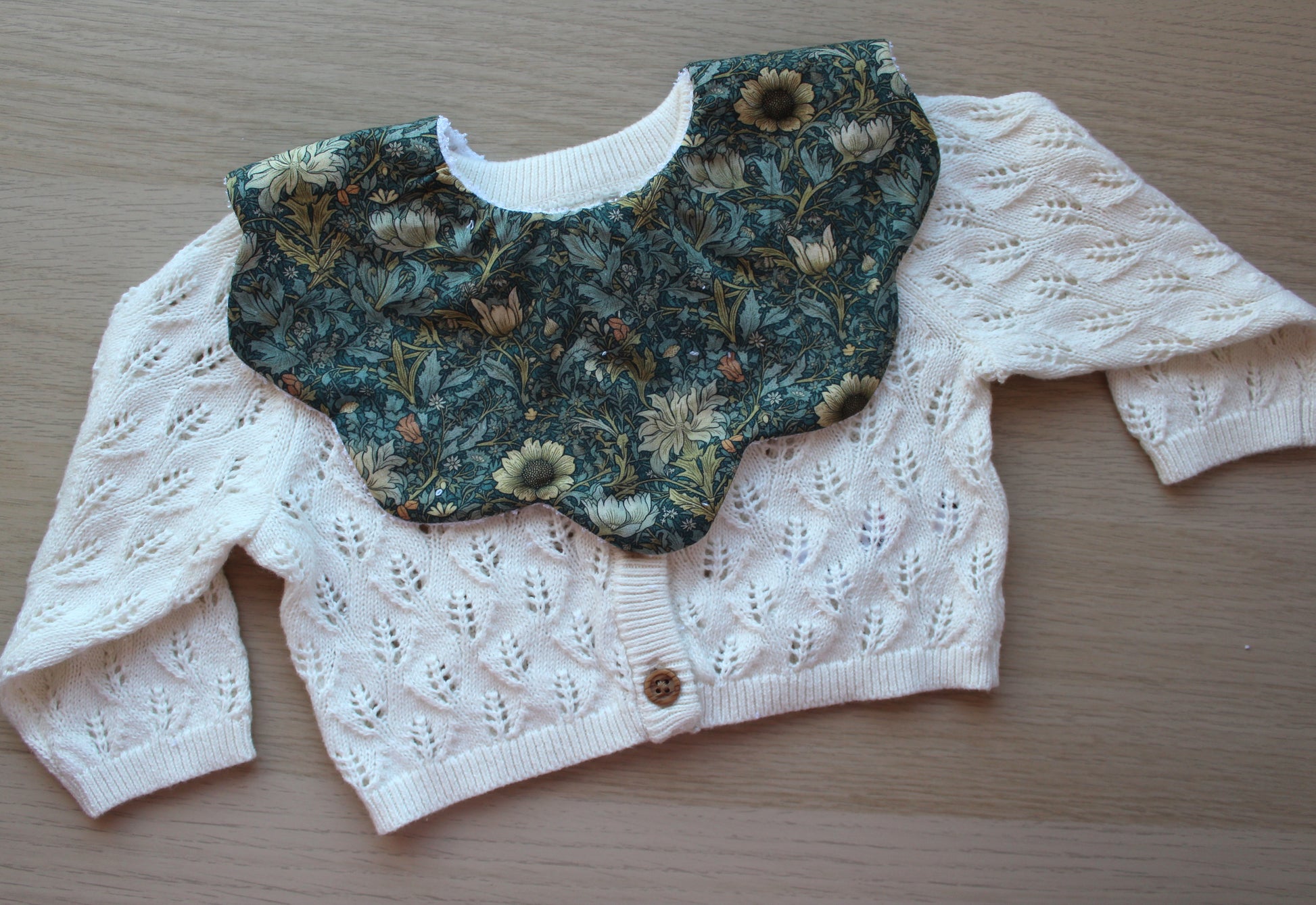 Dark green floral scallop baby bib
