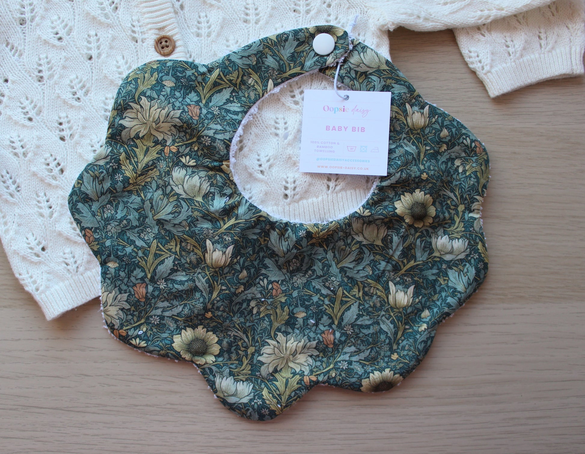 Scallop baby bib with dark green floral Morris design