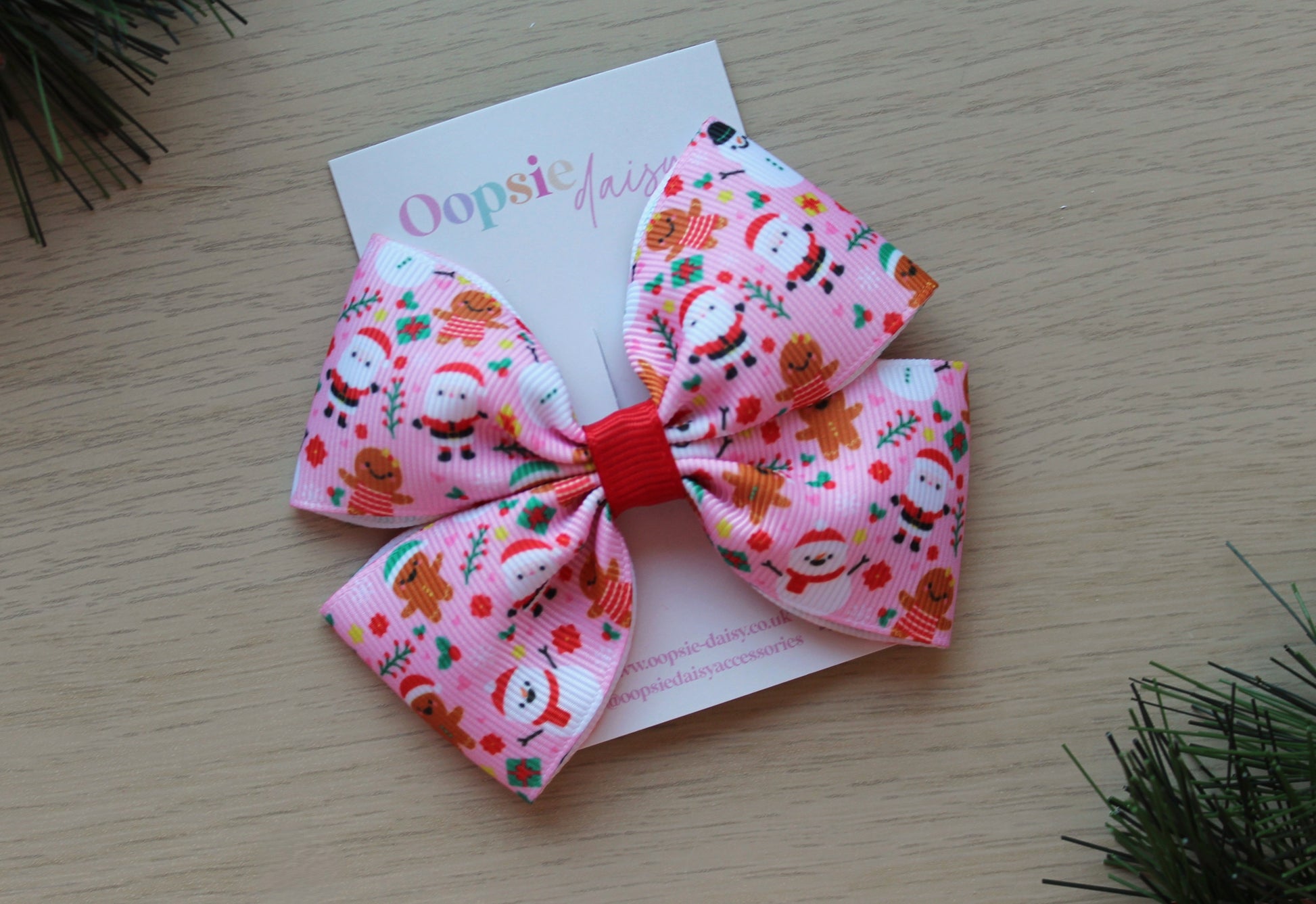 Pink festive hair bow with santa and gingerbread man
