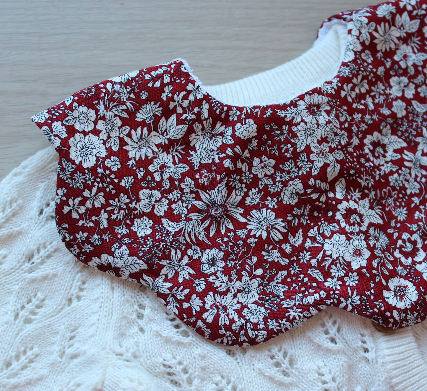 Scalloped baby bib in red floral design from Liberty