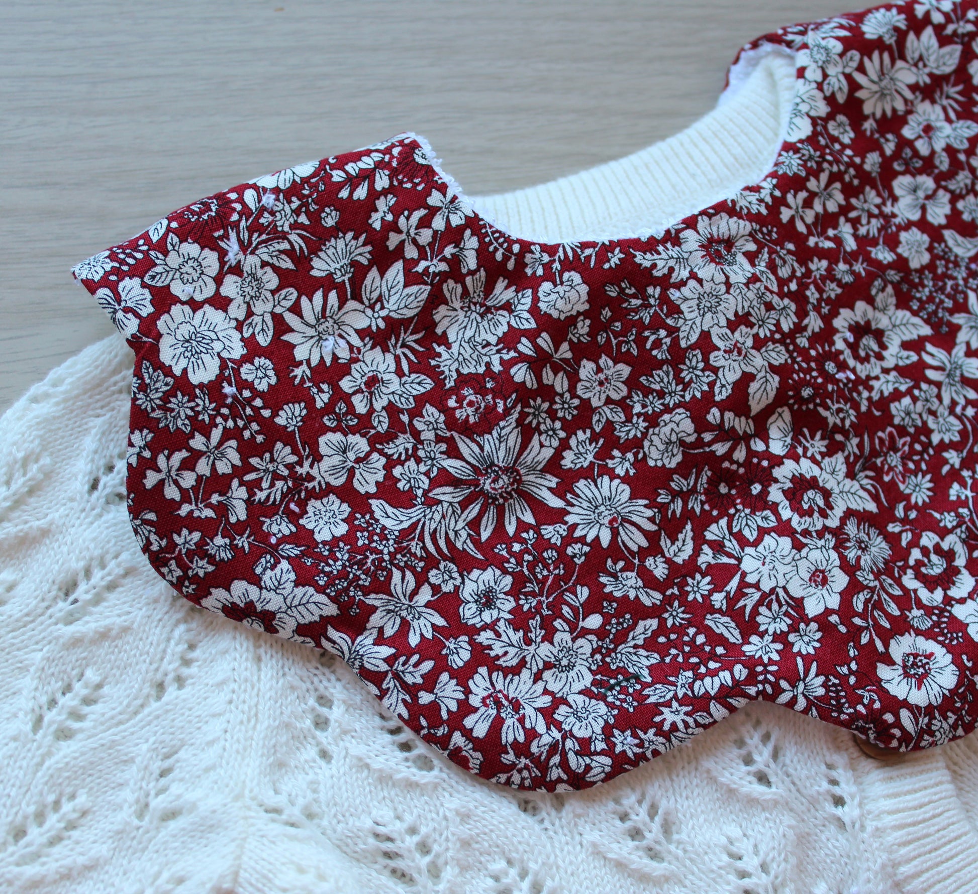 Scalloped baby bib in red floral design from Liberty