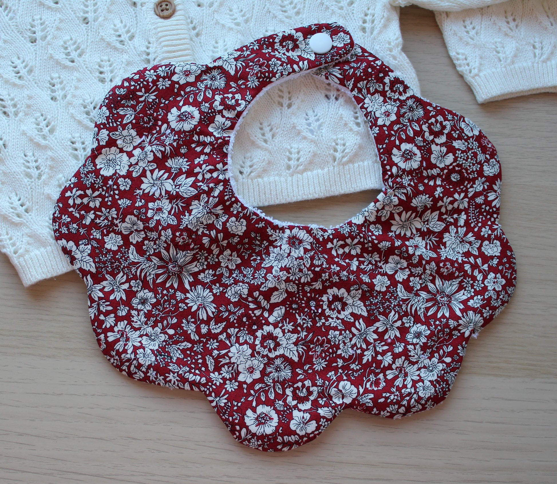 Scalloped shaped baby bib in red floral