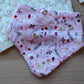 Pink festive baby bib with robins