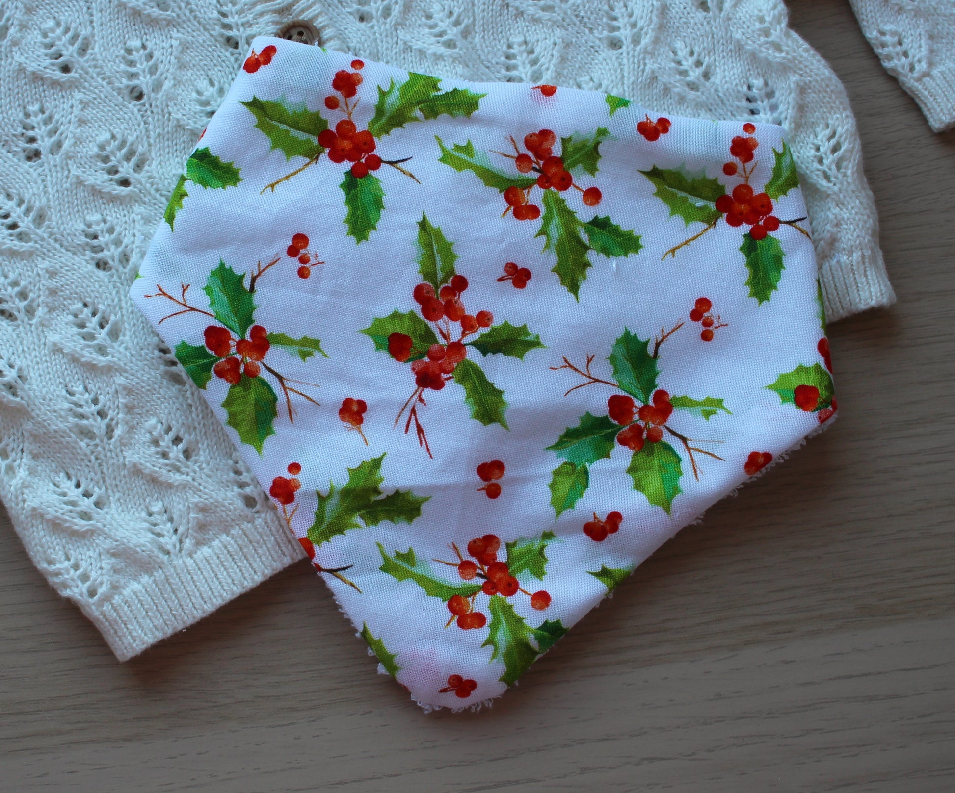 Baby bib with holly berry pattern