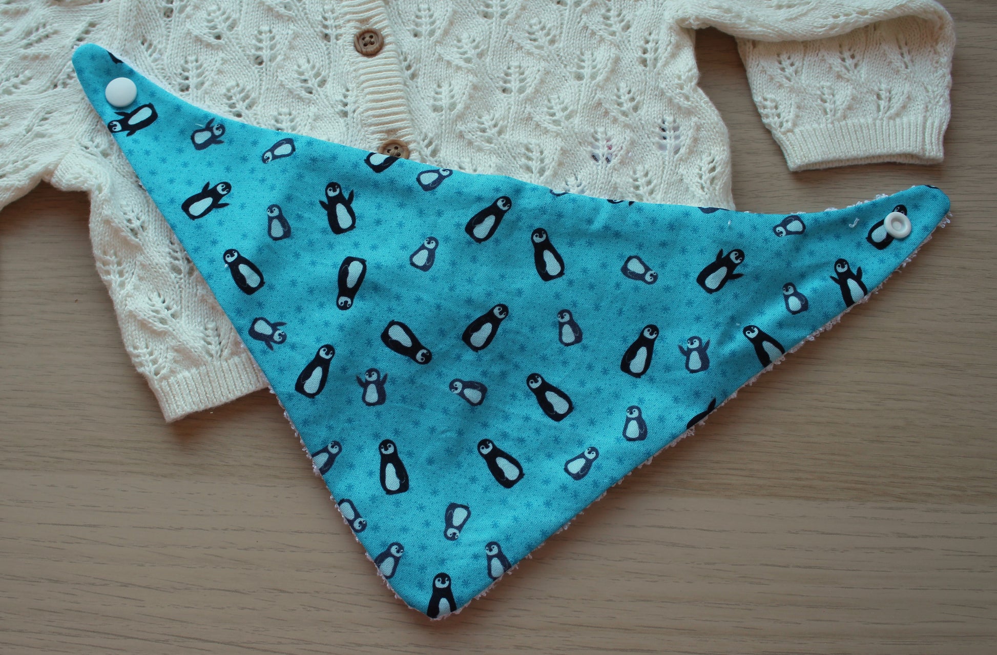 Festive penguin baby bib