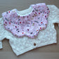 Scalloped baby bib with festive robins and holly leaves
