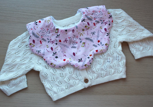 Scalloped baby bib with festive robins and holly leaves