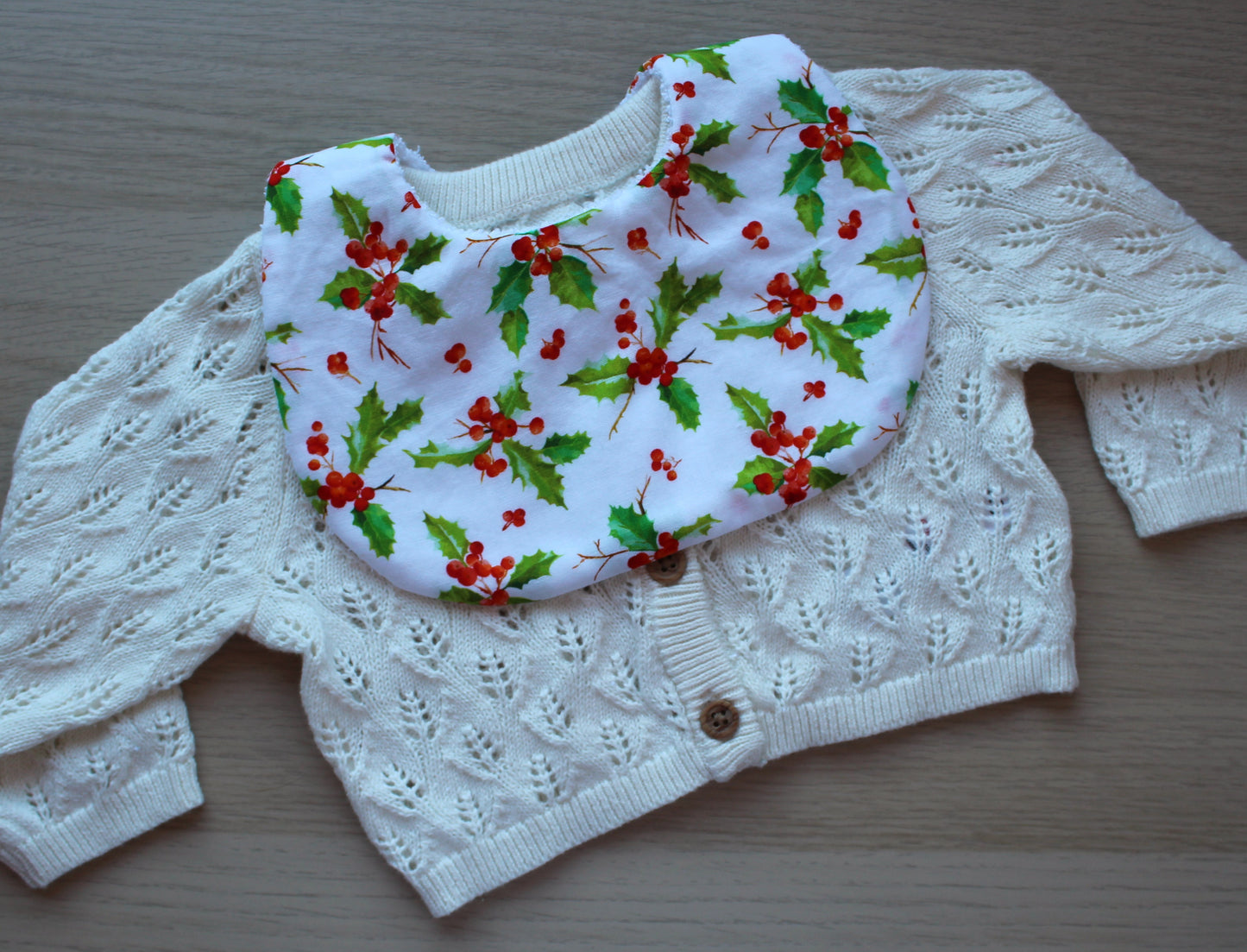 Baby bib with festive holly berry design