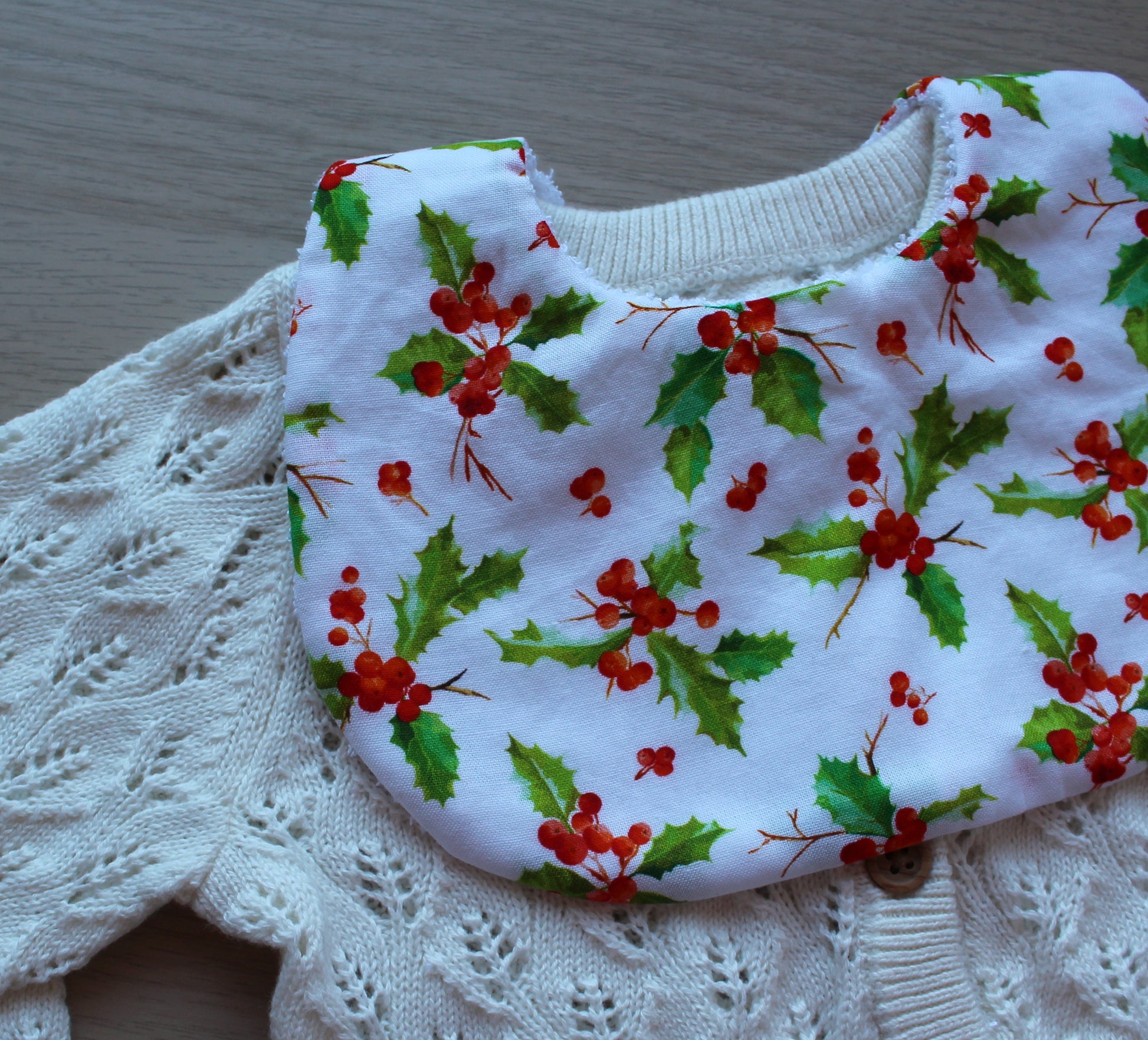 Baby bib with holly and berries