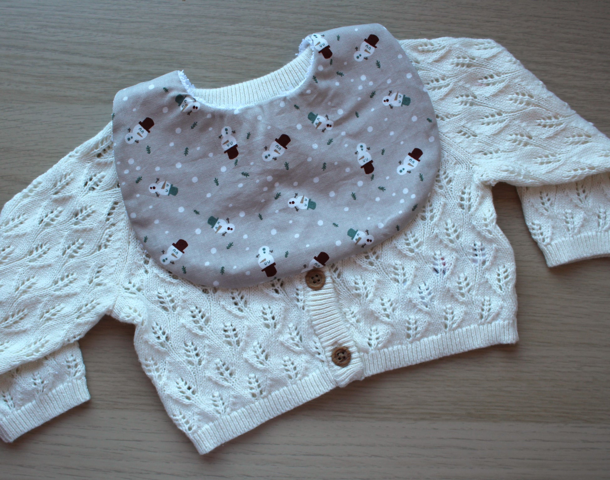 Baby bib with small snowman design