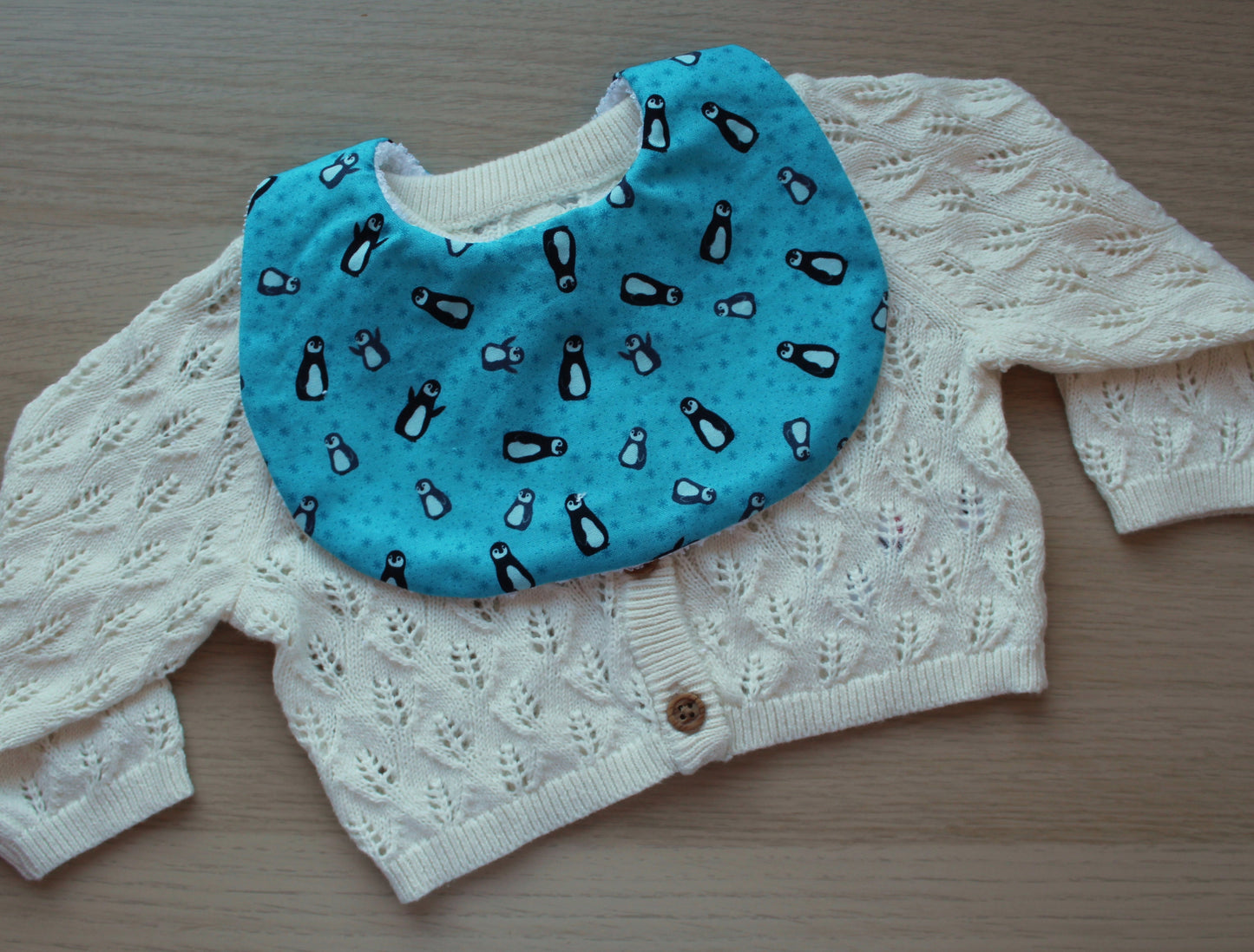 Baby bib in blue with penguins