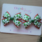 Two Christmas-themed hair bows 