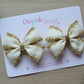 Set of 2 cream hair bows with gold tinsel