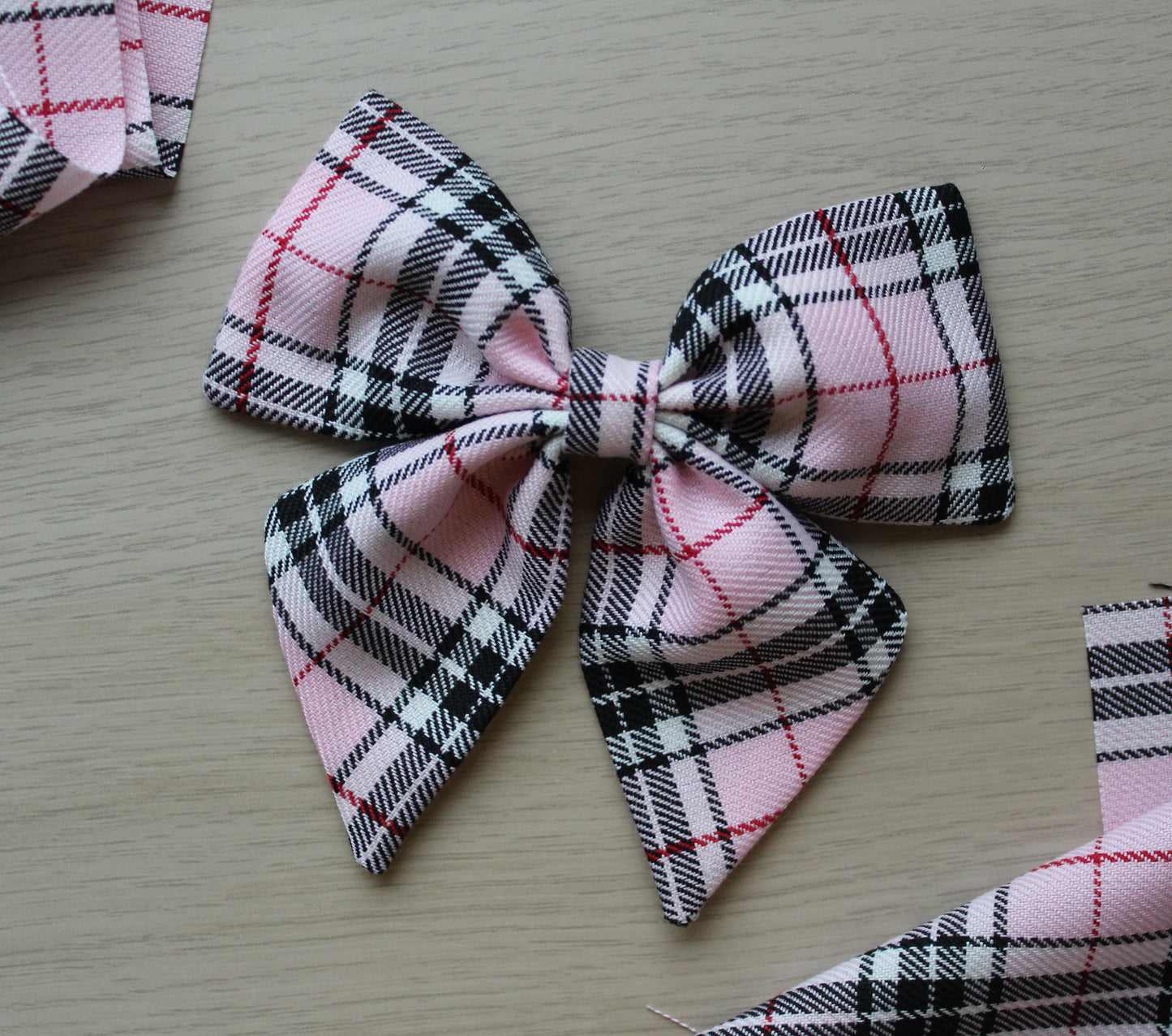 Pink and black plaid tartan hair bow
